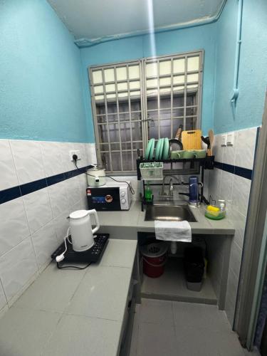 a small bathroom with a sink and a mirror at Apartment in gelugor usm in Gelugor