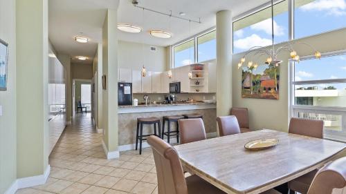 a dining room and kitchen with a table and chairs at Crescent Siesta Key Charmer in Siesta Key