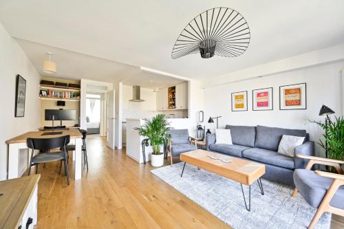 a living room with a blue couch and a table at GuestReady - Central London stay near King's Cross in London