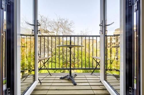 an open balcony with a table on a railing at GuestReady - Central London stay near King's Cross in London