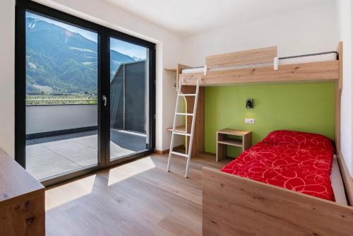 a bedroom with a bunk bed and a large window at Wiesenblick in Ciardes