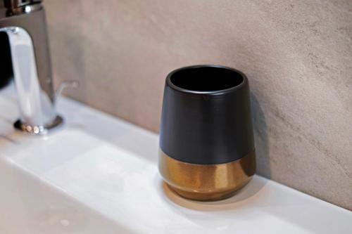 a black and brown vase sitting on a counter at Wiesenblick in Ciardes