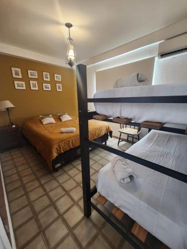 a room with three bunk beds and a couch at El Chabot Fan in Salta