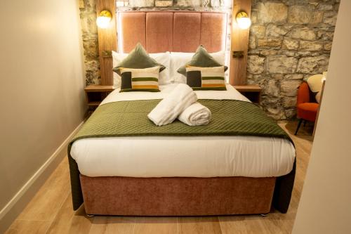 a hotel room with a bed with towels on it at The Woodquay Townhouse in Galway