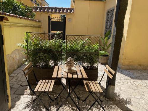 a table and two chairs on a patio at Corte Prini Fiumicino in Fiumicino