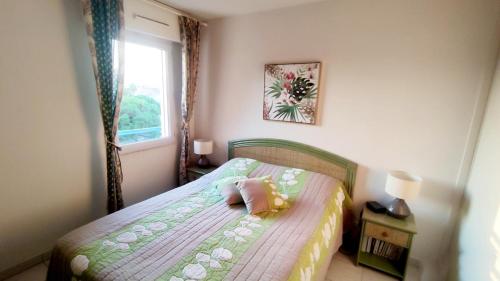 une chambre avec un lit avec un oreiller dessus dans l'établissement Soleil & sable-Fréjus appt 4 pers-Classé 3-Clim, à Fréjus