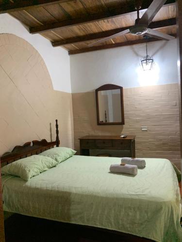 a bedroom with a bed with two towels on it at Hotel San Andrés Mompox Ubicados en el Centro Histórico in Mompos