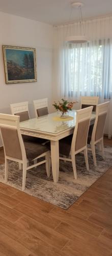a dining room with a table and chairs at Ruža Vetrova A3 in Nova Varoš