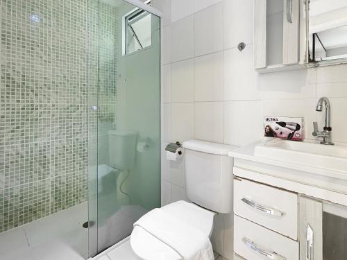 a bathroom with a toilet and a glass shower at Plaza Shopping Barbecue Court 3 bedrooms in Carapicuíba