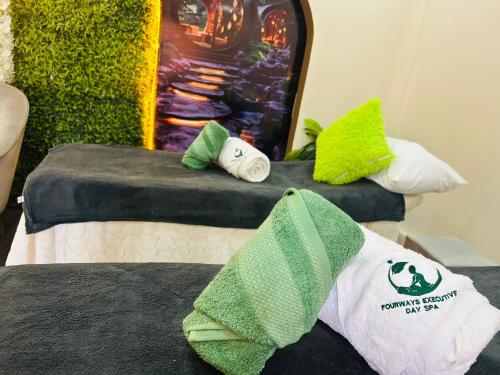a room with two beds with towels on them at Fourways executive spa and accommodation in Sandton