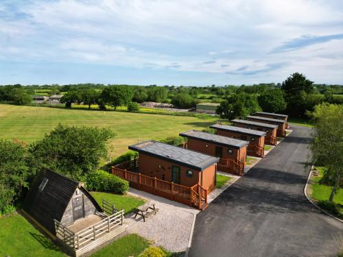 an aerial view of a row of buildings in a field at Royal Umpire Caravan Park in Croston