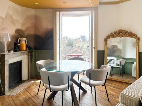 une salle à manger avec une table et des chaises en verre dans l'établissement La suite de Jacobin - Luxe - Centre Historique, à Rennes