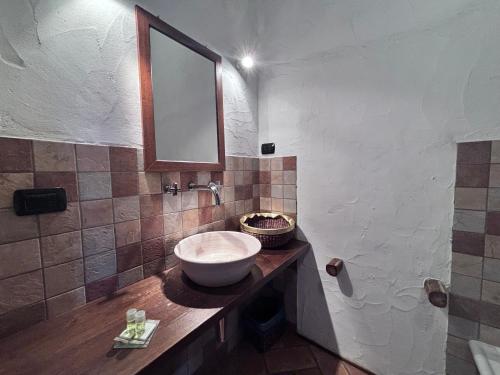 a bathroom with a sink and a mirror at Hammam Rooms, Senorbì, Sardegna in Senorbì