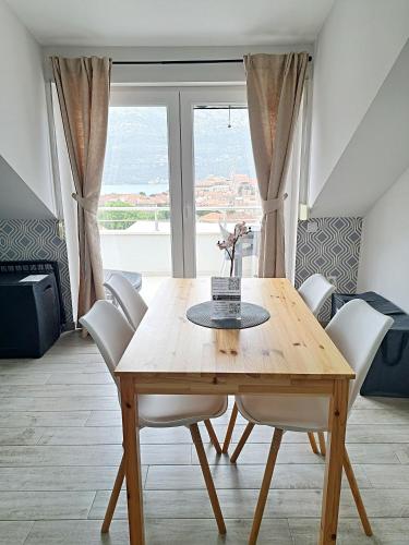 a dining room with a wooden table and chairs at Adriatic Pearl Korcula in Korčula