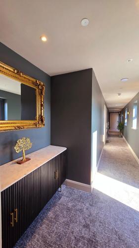 a room with a mirror on the wall and a hallway at The Woodquay Townhouse in Galway