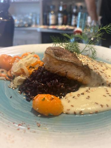a plate of food with meat and beans and vegetables at L'Estampille in Saint-Vidal