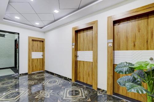a row of doors in a room with plants at Collection O Lotus Gold in Vadodara