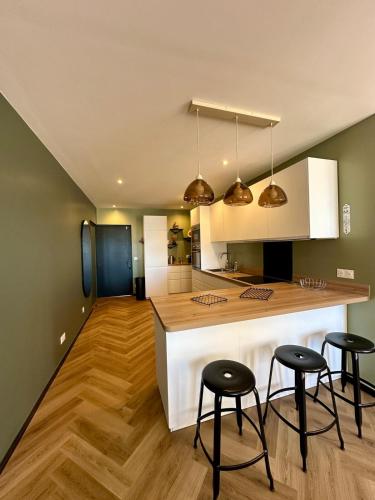 une cuisine avec deux tabourets de bar et un comptoir dans l'établissement LeBellevue, à Sanary-sur-Mer