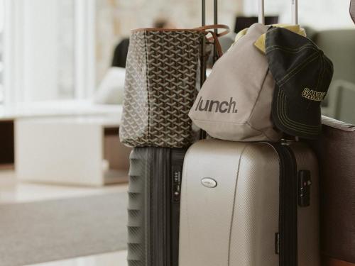 a pile of luggage sitting on top of each other at OTL Gouverneur Saguenay in Saguenay