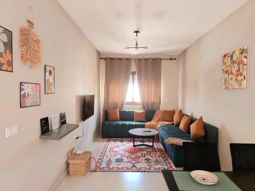 a living room with a couch and a table at Family airport relax apartment in Deroua