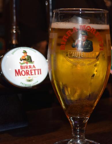a glass of beer sitting on a table at George & Dragon in Dartmouth