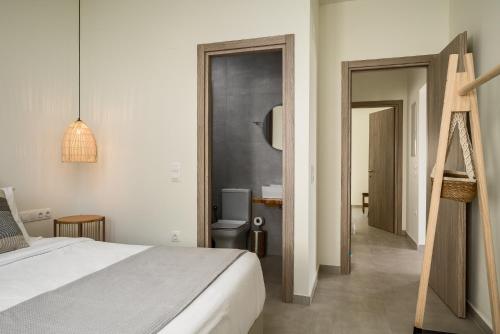 a bedroom with a bed and a bathroom at EuGeniaS Villa in Agios Gordios