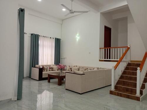 a living room with a couch and a table at Cloud 7 Boutique villa in Kandy