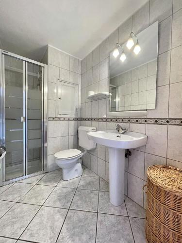 a bathroom with a sink and a toilet and a mirror at Espardell nº4 in Es Pujols