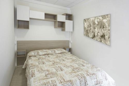 a bedroom with a bed and a painting on the wall at Village Camping Joker in Cavallino-Treporti