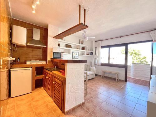 a kitchen with a counter top in a room at Edificio Rex I ES.01 2ª PT.04 in Es Pujols