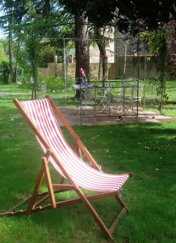 a wooden chair sitting on the grass in a park at Fiori Di Maggio in Muscletto