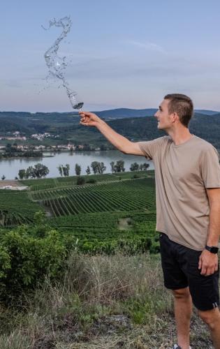 a man standing on top of a hill blowing bubbles at Winzerhof Mörtinger in Dürnstein