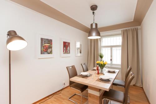 a living room with a table, chairs and a lamp at Prague Center Apartments in Prague