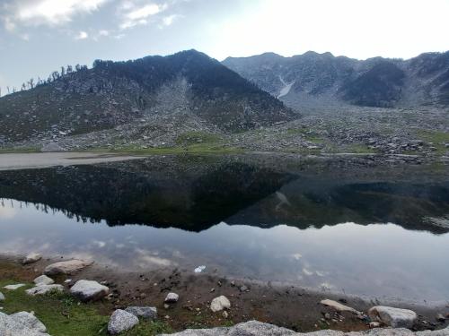 a reflection of a mountain in a body of water at North Katmor homestay in Haripūr