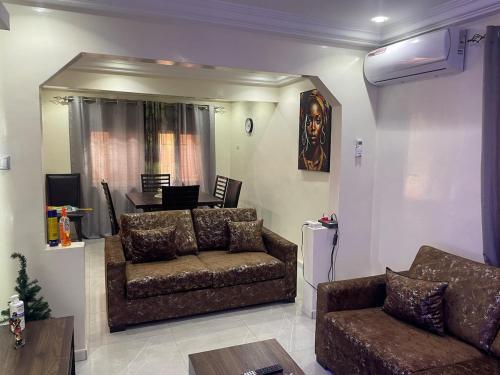 a living room with a couch and a table at Charming and peaceful F3 House in Dakar