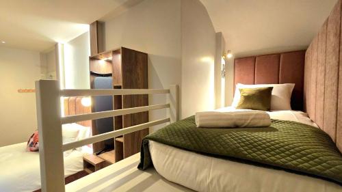 a small bedroom with a bed and a staircase at The Woodquay Townhouse in Galway