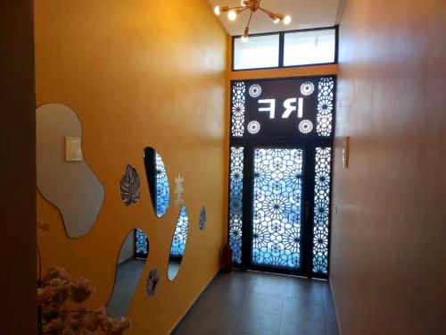 a hallway with a door with a sign on it at Beautiful apartment next to airport Mohamed V in Derroua