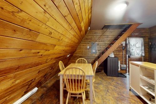 a room with a table and chairs and a wooden wall at Copper Top Ski Chalet in Leavenworth