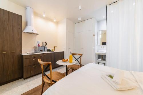 une cuisine avec une table et des chaises dans une pièce dans l'établissement Studio de charme quartier tour eiffel - 2P, à Paris