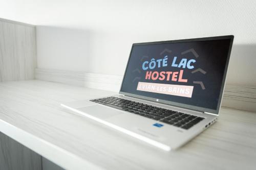 a laptop computer sitting on top of a desk at Côté Lac Hostel Evian in Évian-les-Bains
