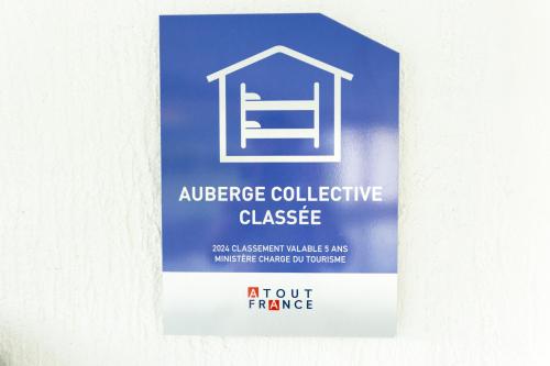 a sign hanging on a wall with a house on it at Côté Lac Hostel Evian in Évian-les-Bains