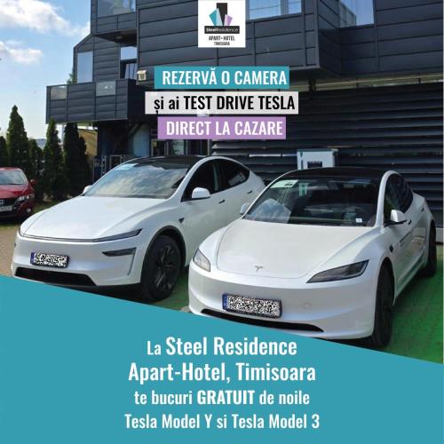 two white cars parked in front of a building at Apartments Steel Residence -Tesla Test Drive and 120 kW Supercharger in Timişoara