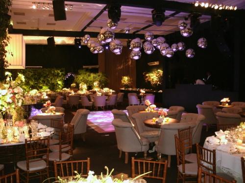 a banquet hall with tables and chairs and chandeliers at Itu Plaza Hotel in Itu
