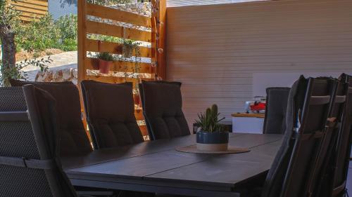 a table and chairs with a plant on a patio at Val Lodge Šimuni in Šimuni