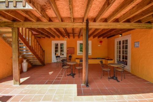 a patio with tables and chairs in a house at Penedo Escape Nature in Colares