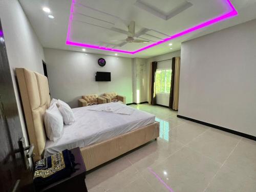 a bedroom with a bed with a pink lighting at Sweet Villa Guest house Islamabad G9-4 in Islamabad