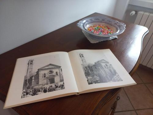 an open book on a table with a bowl of candy at La testuggine in Giussano