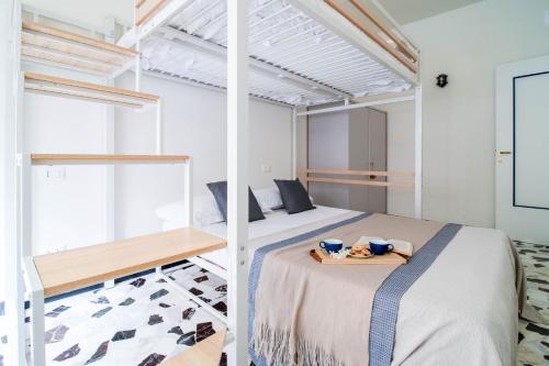 a bedroom with a bed with a tray on it at Casa Alyx by PortofinoHomes in Santa Margherita Ligure