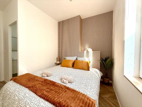 une chambre avec un lit avec deux animaux en peluche dessus dans l'établissement Oasis Marocaine avec Terrasse Privée, à Reims