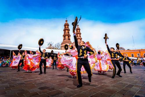 a group of people in traditional dances in front of a building at A 90m de Feria, Céntrico y Acogedor - Departamento A220-2 in Aguascalientes